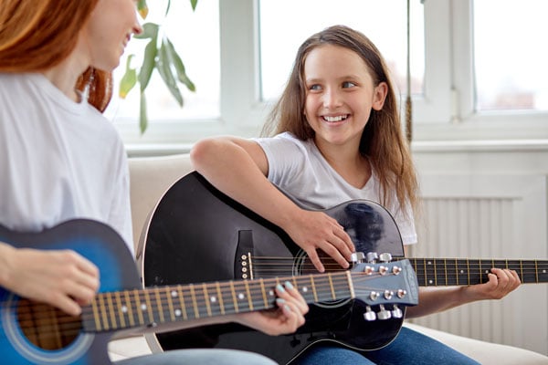 LAU student learning guitar