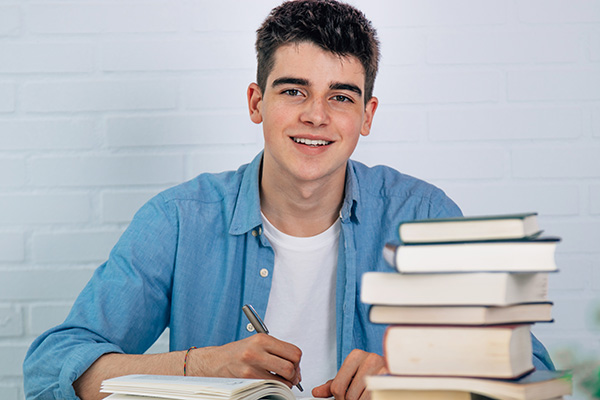 LAU student with stack of books